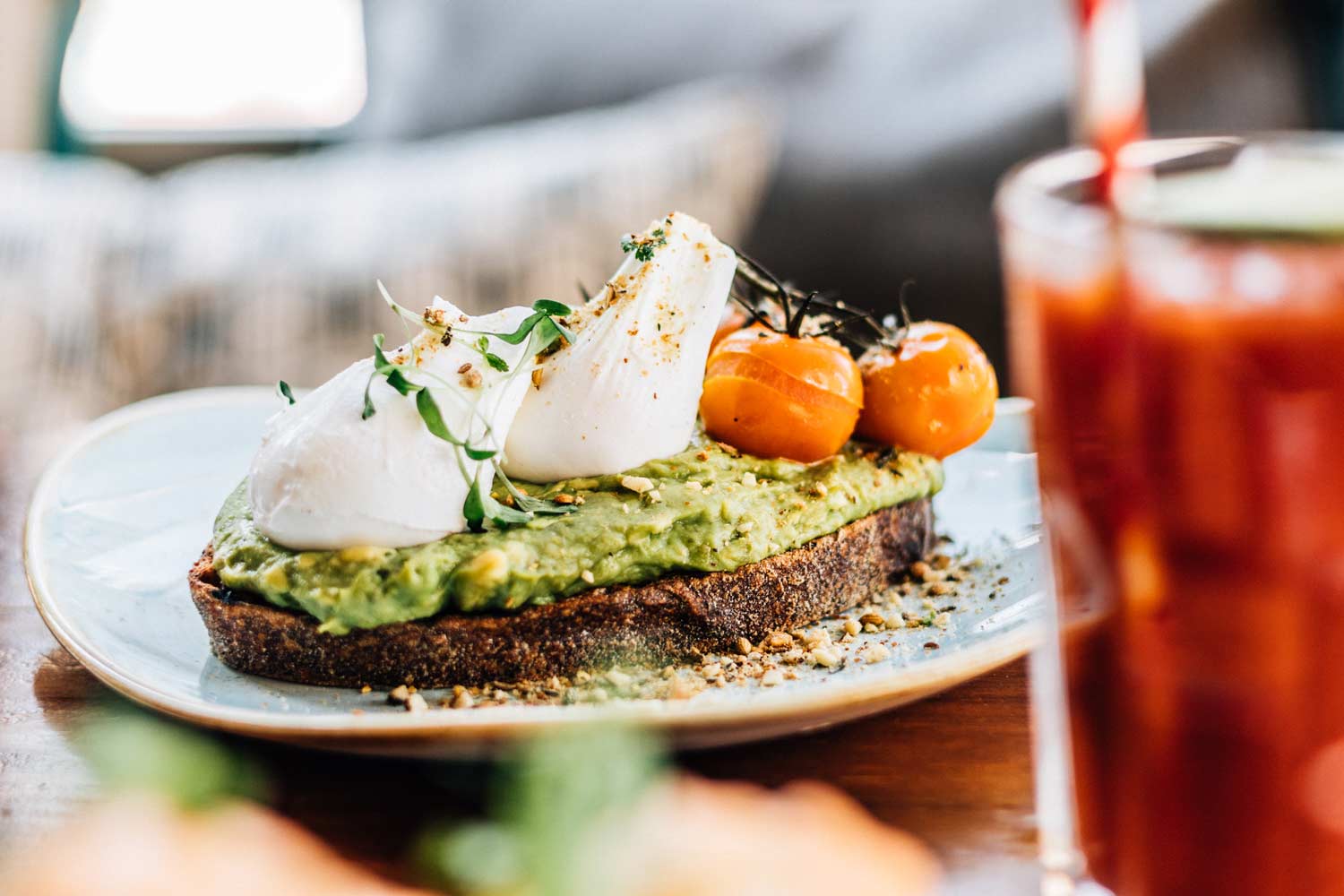 Avocado toast with poached eggs and tomatoes